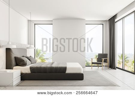 Luxury Bedroom Interior With White Walls, A Concrete Floor With A Carpet, Loft Windows And A Master 