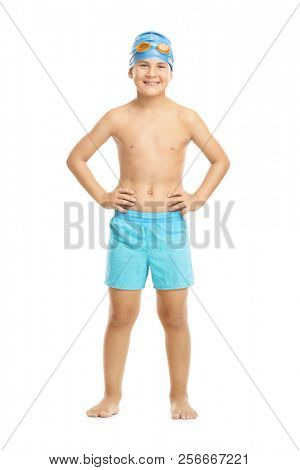 Joyful little kid with a blue swim cap and orange swimming goggles looking at the camera isolated on white background
