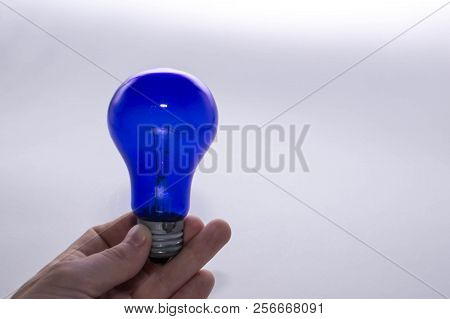 Blue Lamp Without A Plafond In Hand On A White Background