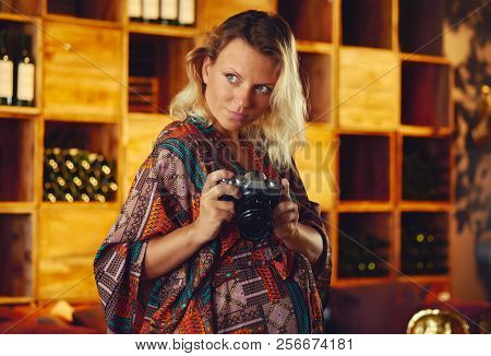 Portrait Of A Young Pregnant Pensive Blond Woman Holding Photo Camera And Looking Away, Wine Chiller