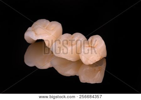 Dental Ceramic Veneers And Crowns Isolated With Mirror Background.