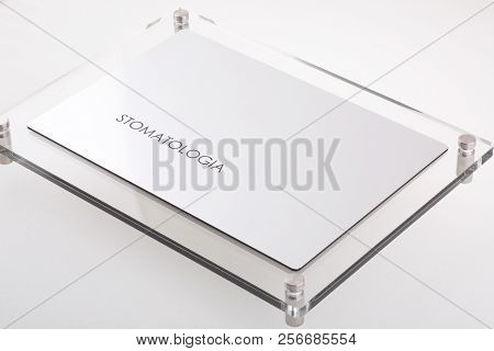 Stomatologia - Plastic Blank With Text On White Background. Silver Color.
