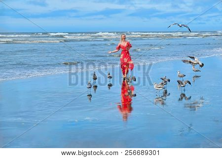 Beach Vacation. Woman Running On Beach By Sea With Seagulls. Ocean Shores In Olympic Penincusula.  S