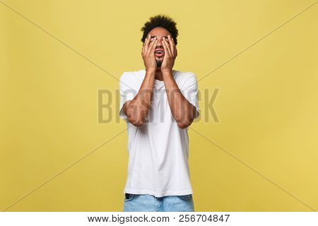 Closeup Portrait Man With Sad Expression, Isolated On Yellow Wall Background. Human Emotions, Body L