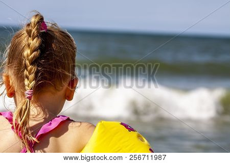 Happy Little Girl With Floaties Floaties Preparing To Swim In The Ocean