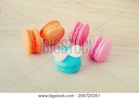 Sweet Macaroons On Wooden Background In Soft Focus With Pastel Filter