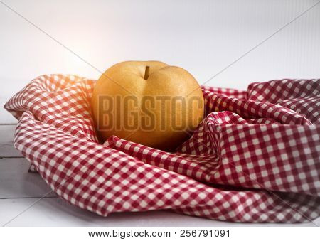 The Chinese Pear Put On Table Cloth,warm Light Tone,blurry Light Around