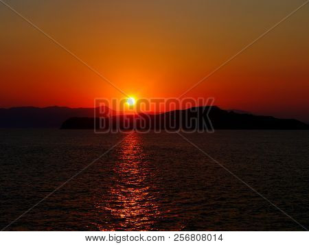 Orange Sunset In Summer At The Greek Sea. Greece Crete Iguana Beach Sunset.