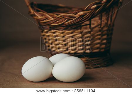White Chicken Eggs With Wodden Basket On A Tablecloth