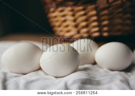 White Chicken Eggs With Wodden Basket On A Tablecloth