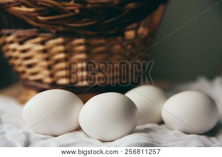 White Chicken Eggs With Wodden Basket On A Tablecloth