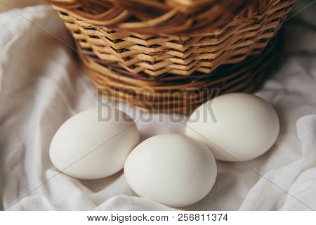 White Chicken Eggs With Wodden Basket On A Tablecloth