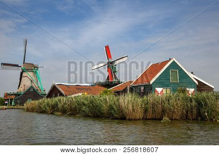 Traditional, Authentic Dutch Windmills At The River Zaam In Zaanse Schans Village.