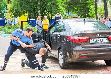 A Policeman, A Road Policeman In A Blue Uniform, Fights, Delays, Arrests A Criminal Driver Of A Car.