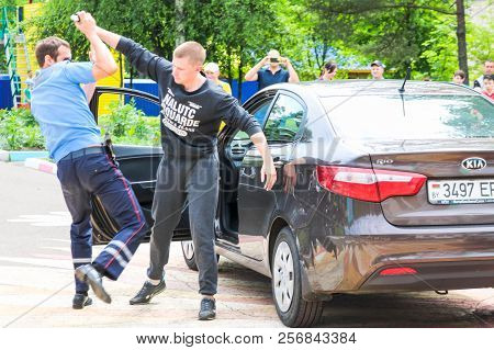 A Policeman, A Road Policeman In A Blue Uniform, Fights, Delays, Arrests A Criminal Driver Of A Car.