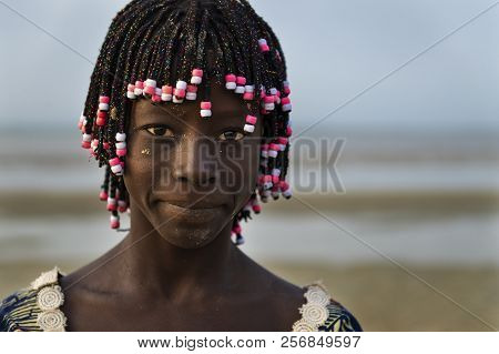 Orango Island, Guinea-bissau - February 2, 2018:  Portrait Of A Beautiful Young Girl In The Beach In