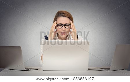 Depressed Tired Unhappy Business Woman Siting At Desk In Front Of Many Laptop Looking Gloomy Isolate