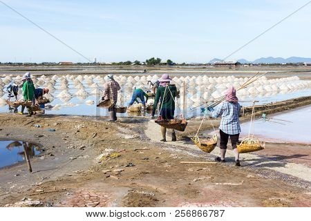 Petchaburi, Thailand - 12th August 2017: Workers Gathering Sea Salt From The Salt Pans.the Farms Oft