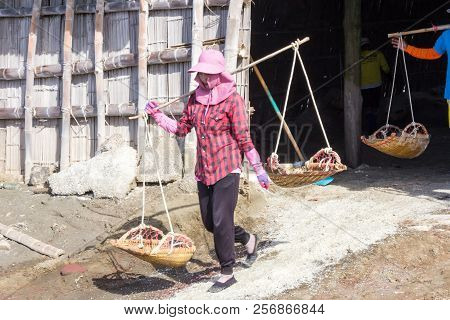 Petchaburi, Thailand - 12th August 2017: Workers Leaving The Warehouse To Gather Sea Salt From The S