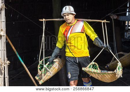 Petchaburi, Thailand - 12th August 2017: Workers Leaving The Warehouse To Gather Sea Salt From The S