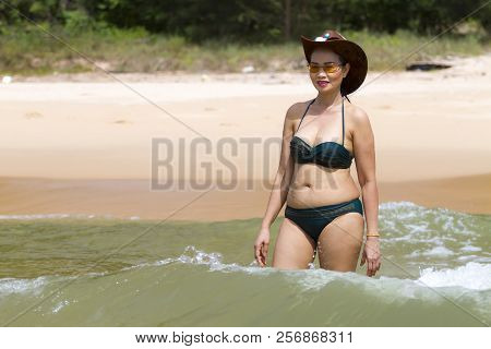 Woman Show Pretty Enjoy With Bikini Hat And Wave On Beach At Bang Beot Beach, Chumphon Province Thai