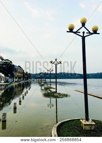 Flores, Guatemala - May 24th, 2018: The Boardwalk Of Flores, Guatemala Overrun By Rising Waters, Pot