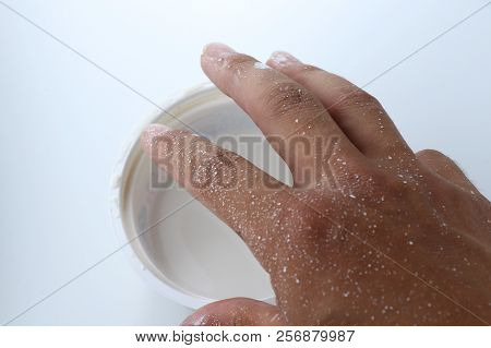 A Detail On Painter´s Hand And Cup With White Paint For Painting. White Background