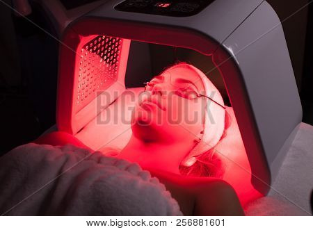 Young Woman Having Led Light Facial Treatment In Beauty Salon