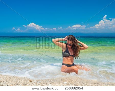 woman sunbathing on the beach summer travel holidays
