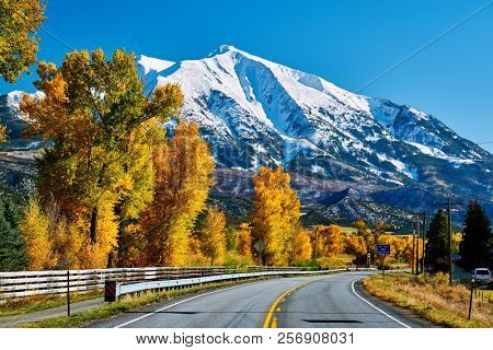 Highway in Colorado Rocky Mountains at autumn, USA. Mount Sopris landscape.