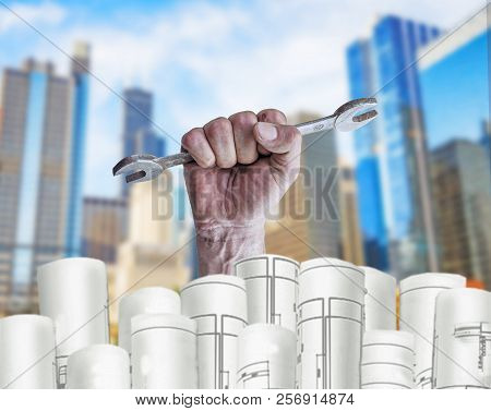 Hand Holding Pilers With Architect Plans And City Background