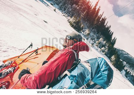 Man Near The Tent In Winter. Tourist In Extreme Conditions. Snow Shoes, Trekking Poles And Backpack.