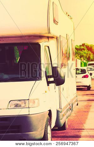 Vancamper Motorhome Parked In Street. Summer Sunset Green Trees Nature Background. Warm Sunlight. Va
