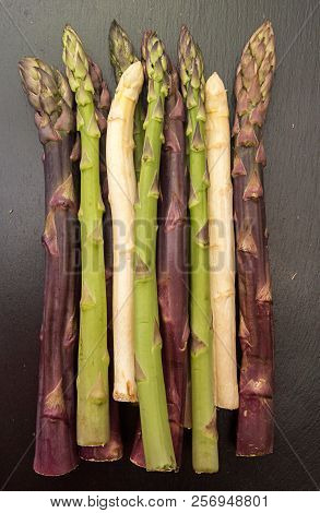 Purple Green White Asparagus Flat Lay On Black Stone Background. Vegetarian Dieting Organic Healthy 
