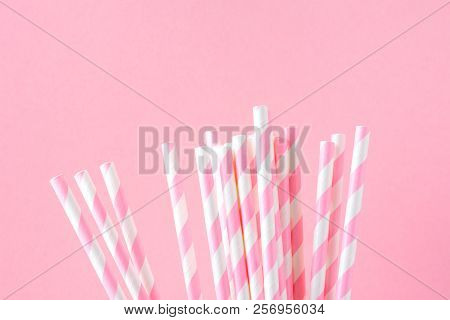 Bunch Of Elegant White Striped Paper Drinking Straws On Pink Background. Birthday Party Babyshower I