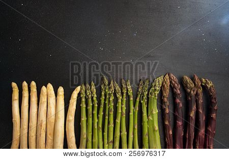 Set Collection Purple Green White Asparagus Flat Lay On Black Background. Vegetarian Dieting Organic