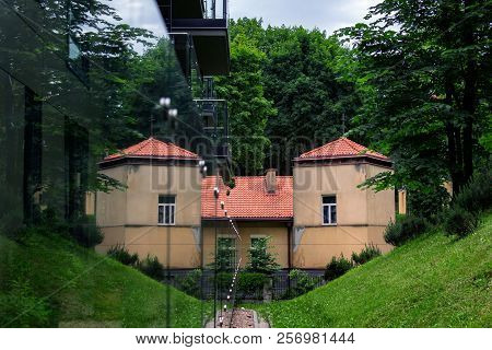 Reflection Of A Part Of Living Building With Red Roof Making It Look Like A Castle. Fusion Of Epochs