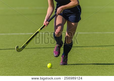 Hockey Action Abstract Photo Of Unidentified Girl Player Running Legs Ball And Stick On Astro Turf.