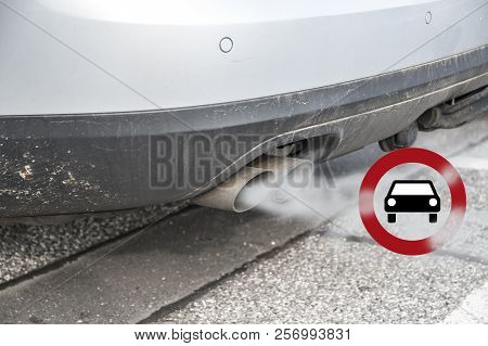 Double Exhaust From A Car With Smoke And The Traffic Sign For Driving Ban, In German Fahrverbot For 