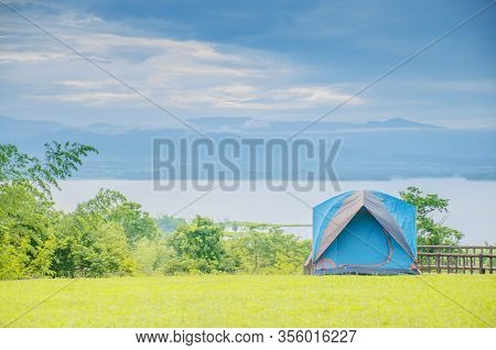 Camping Trip Tent On Holiday. Adventures Camping Tourism And Tent.  Beautiful Lake With Tent In Plac