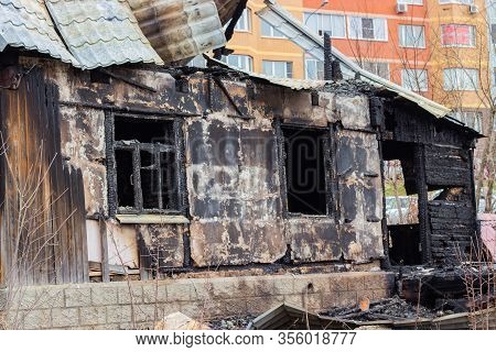 The Charred Wall Of The House, The Arson Close-up. The Destruction Of A Village House On The Outskir