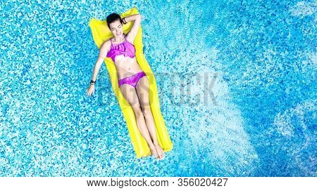 Beautiful Young Woman In Hat In Swimming Pool Aerial Top View From Above, Young Girl In Bikini Relax