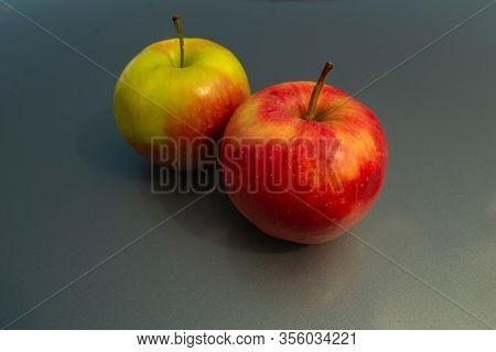 Juicy Ripe Apple Fruits On A Gray Background