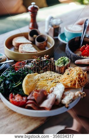 Morning Breakfast On A Table, Waffles With Cream, Berries, Coffee, Cappuccino, Bowl, Omlet With Vege