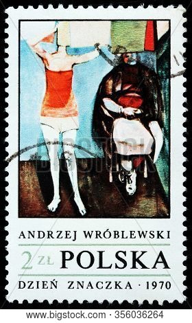 Luga, Russia - October 15, 2019: A Stamp Printed By Poland Shows Painting Woman Hanging Up Laundry, 
