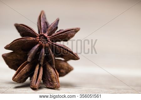 Star Anise With And Without Seeds, Closed, On A Light Wooden Surface. Spice For The Recipe. Beautifu
