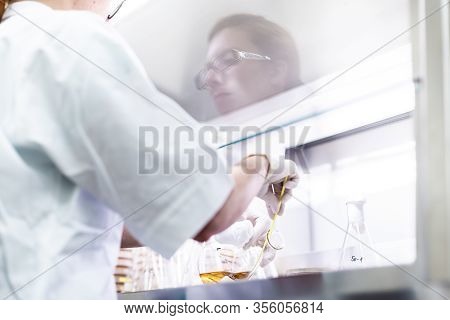 Female Scientist Working With Laminar Flow At Corona Virus Vaccine Development Laboratory Research F