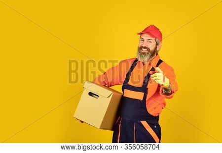 Happy Man Cardboard Box. Carrying Boxes Inside The Building. Unpacking Moving Boxes. New House At Mo