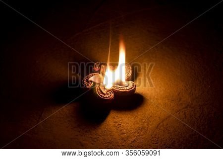 Glowing Clay Lamp In Dark Night On The Floor - Happy Diwali, Light Festival, Illuminated Lights