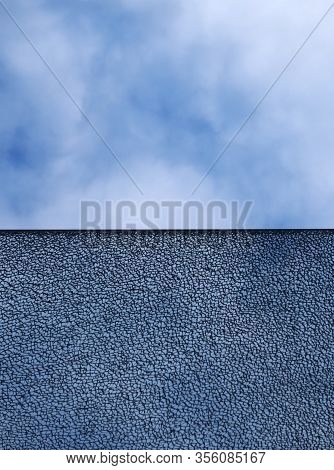 A Pane Of Shattered Glass With Straight Edge Dividing The Image Against A Blue Cloudy Sky